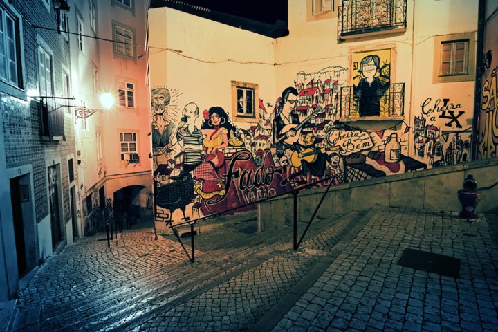 a graffiti covered building in Lisbon during the night